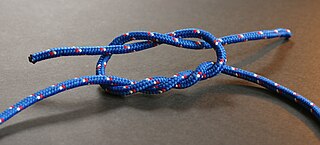 Surgeon's knot tying process joining two fishing lines